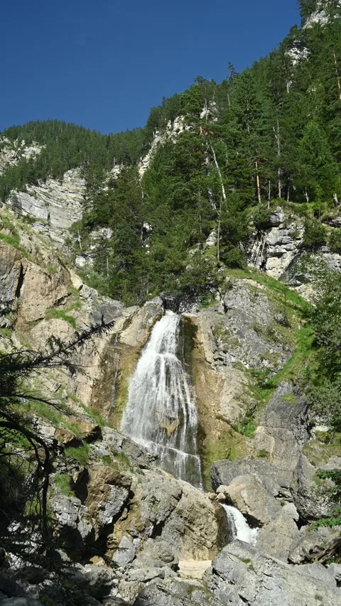 View of a waterfall in the mountains between rocks, in late summer 스톡 동영상 260870173
