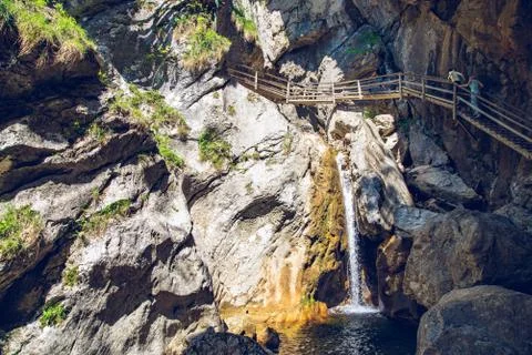 View at waterfall path along mountain stream. Tourist spot. Travel destinatio Stock Photos