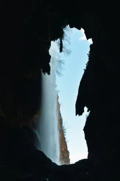 View of a waterfall through a cave in the mountains in Mallos de Riglos, Arag Stock Photos