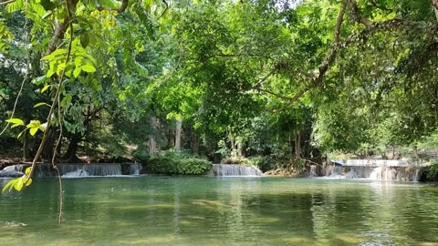View of a waterfall with water flowing over rocks. In the forest after the rain 스톡 동영상 250440302