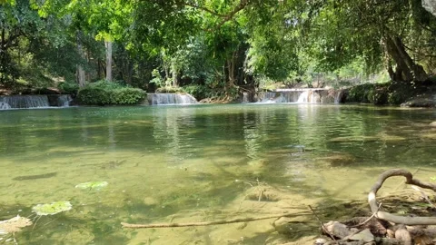 View of a waterfall with water flowing over rocks. In the forest after the rain 스톡 동영상 250440313