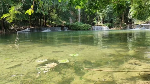 View of a waterfall with water flowing over rocks. In the forest after the rain 스톡 동영상 250440314