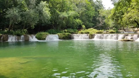 View of a waterfall with water flowing over rocks. In the forest after the rain 스톡 동영상 250440329