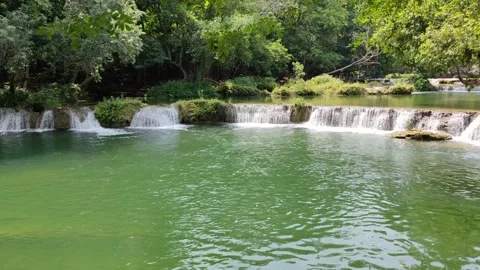 View of a waterfall with water flowing over rocks. In the forest after the rain 스톡 동영상 250440330