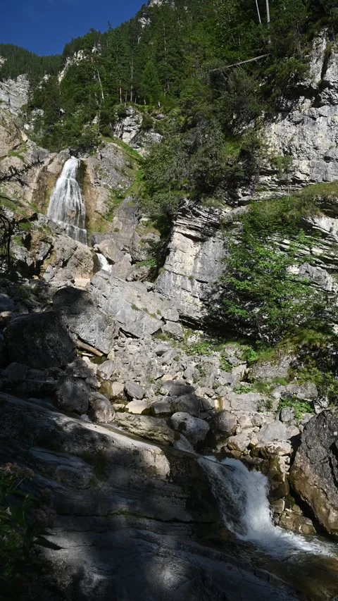 View of waterfalls in the mountains between rocks, in late summer, vertical shot Stock-Footage 260870202