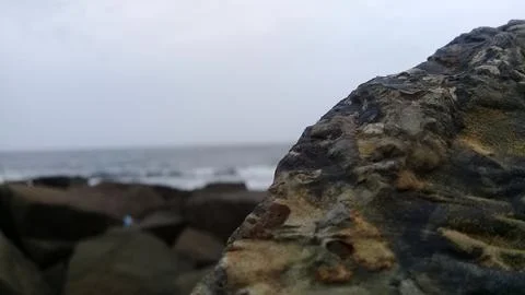 View of the waves and rocks on the beach Stock Photos