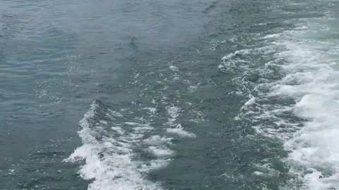 View of the waves behind a large cruise ship boat at the deep blue sea.  Az.. Video stock 277664936