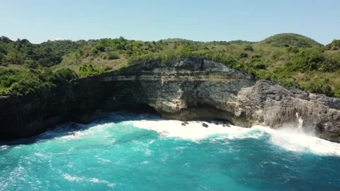View on waves break on rock cliff Stock Footage 162569174