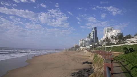 A view of waves breaking on the beach and along the promenade to resorts. Stock Footage 171456690