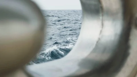 View of waves caused by the ship through a small hole Stock Footage 100389544