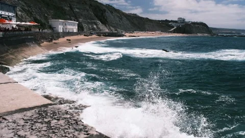 View of waves crashing on the shore of beach town, Portugal, HD Stock Footage 150759696