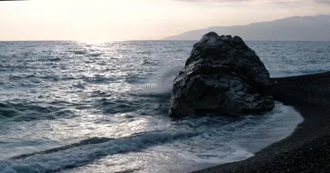 View of Waves Rolled at Sea Coast Line With Huge Rock at Sunset Stock Footage 68819554