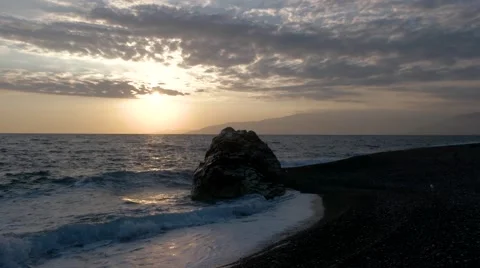 View of Waves Rolled at Sea Coast Line With Huge Rock at Sunset Stock Footage 68843548