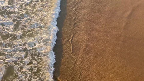 View of waves rushing in on the sand from above Stock Footage 247409783