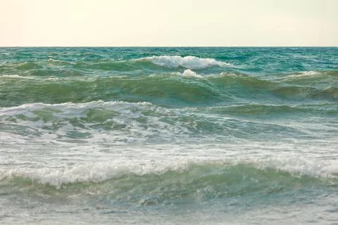View of the waves at sunset. Background Stock Photos