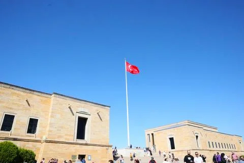 View of waving Turkish flag between the buildings at Anitkabir museum Stock Photos