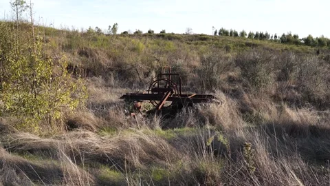 View of a weathered, rusty engine that rests in an agricultural well, its aging 스톡 동영상 328135276