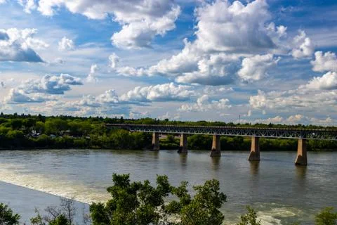 View of the weir with the train bridge in the background 스톡 사진