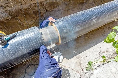 View on welding team of welders until them assembly a new pipeline Stock Photos
