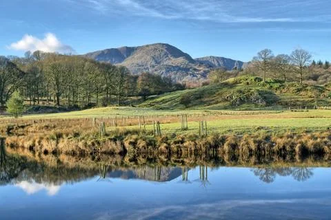 A view of Wetherlam reflected in Elterwater. Stock Photos