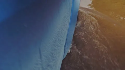 View of a wheel passing through a long puddle from the window of a moving car. Stock Footage 143313670