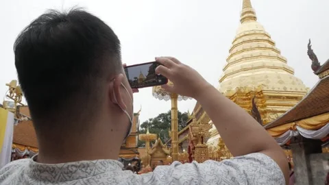View while an asian man take photo of famous giant golden pagoda among fog .. Stock Footage 284210452