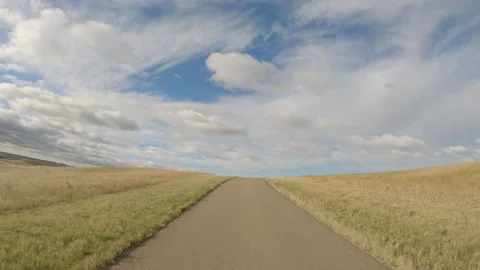 View while driving along a twisting narrow road at autumn grassland and beautifu Stock Footage 287107194