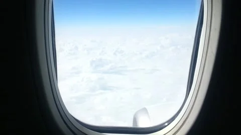 View of white clouds and airplane wings from an airplane window. Flying abroad o Stock Footage 40257732