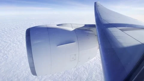 View of white clouds and and a wing with a turbine. Stock Footage 195844572