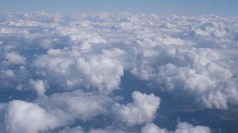 View of the white clouds and Earth from the airplane porthole. Video stock 242036534