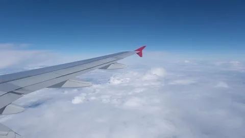 View of the white clouds and Earth from the airplane porthole. Stock Footage 243729721