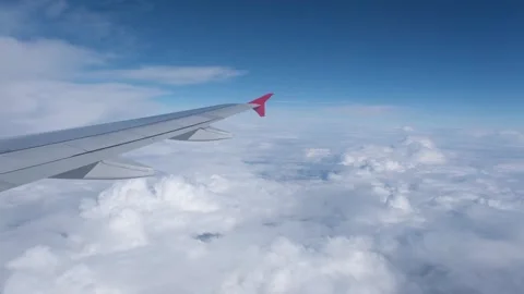 View of the white clouds and Earth from the airplane porthole. Stock Footage 252123486