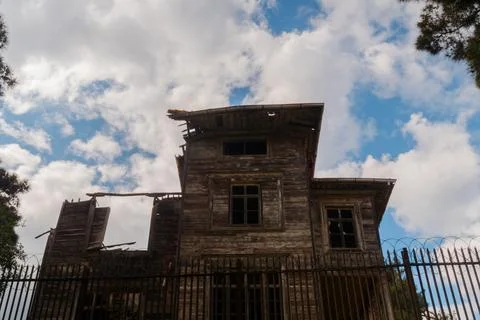 View of white clouds over old ramshackle historic wooden building Fotos de archivo