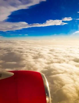 View of white Clouds from plane window. Sun rays shining on white clouds Stock Photos