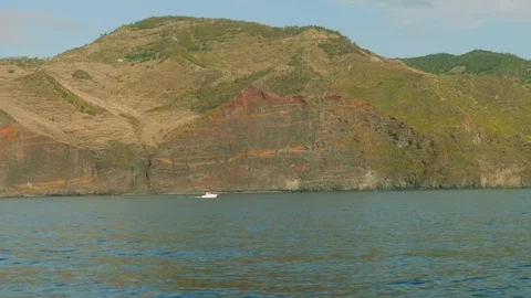 View of white fish boat sailing along Madeira rocky shore Stock Footage 88550885