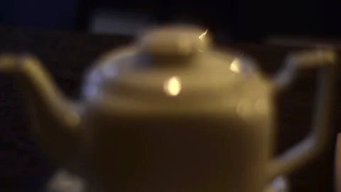 View of a white, retro vintage, ceramic teapot in a dark interior. Stock-Footage 129711025