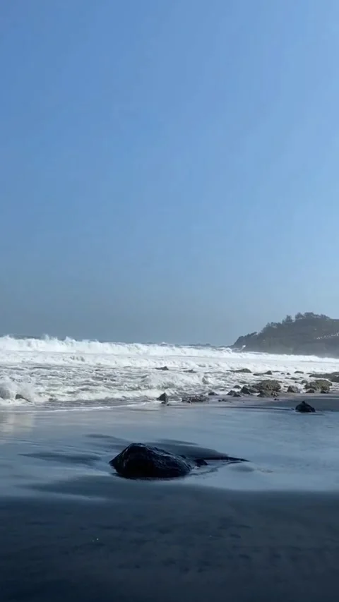 View of white sand beach with visitors playing in the water Stock Footage 308510267