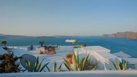 View from a white washed terrace overlooking the caldera sea Stock Footage 341460497