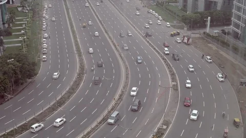View of a wide road and passing vehicles along the business centre town of north Stock Footage 101410316