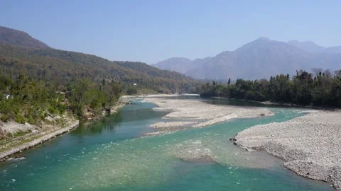 View of a wide turquoise river flowing through a valley, Nepal. Stockbeeldmateriaal 335603466