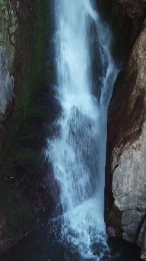 View of wild Akkum waterfall rushing through tight rock fissure in Kazakhstan Видео 338128960