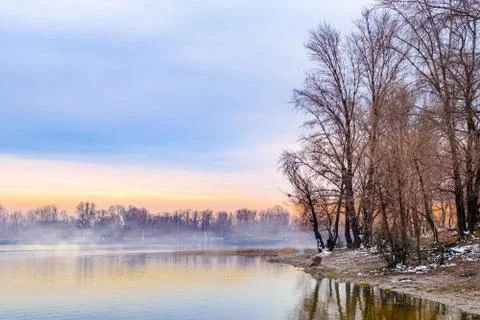 View of willow trees and poplars close to the  foggy Dnieper River in Kiev 写真素材