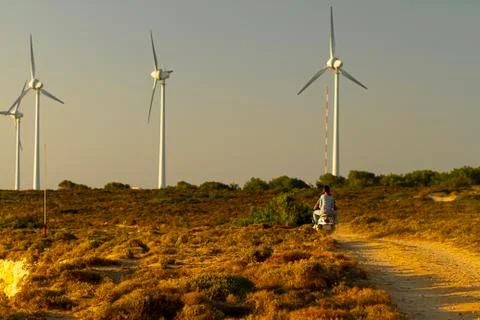View of the wind farm in west cape of Bozcaada at sunset. Stock Photos