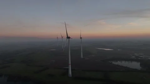 View of wind power station in field at sunset Stock Footage 297081425