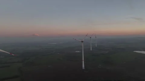 View of wind power station in field at sunset Stock Footage 297137192
