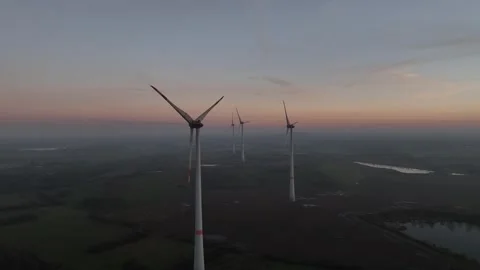 View of wind power station in field at sunset Stock Footage 297137378