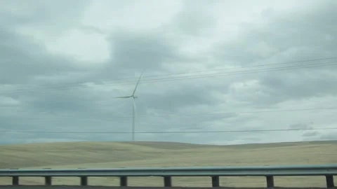 View of a wind turbine in Oregon from a moving car Stock Footage 327769374