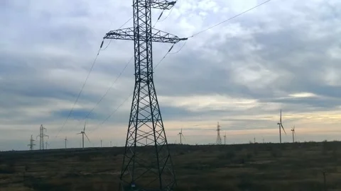 View of wind turbines and high voltage lines from the car window 스톡 동영상 282539241