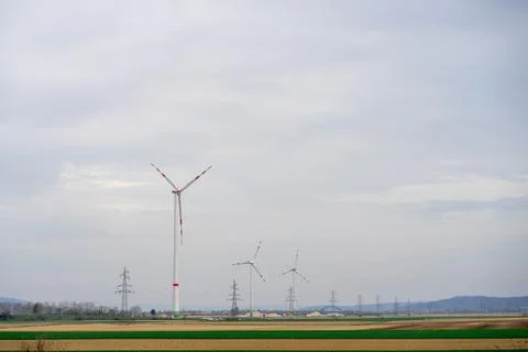 View of wind turbines generating renewable energy among fields in Austria Foto stock