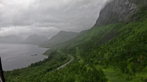 View of winding coastal road and green mountains in Bergsbotn Senja Norway Stock-Footage 342340356